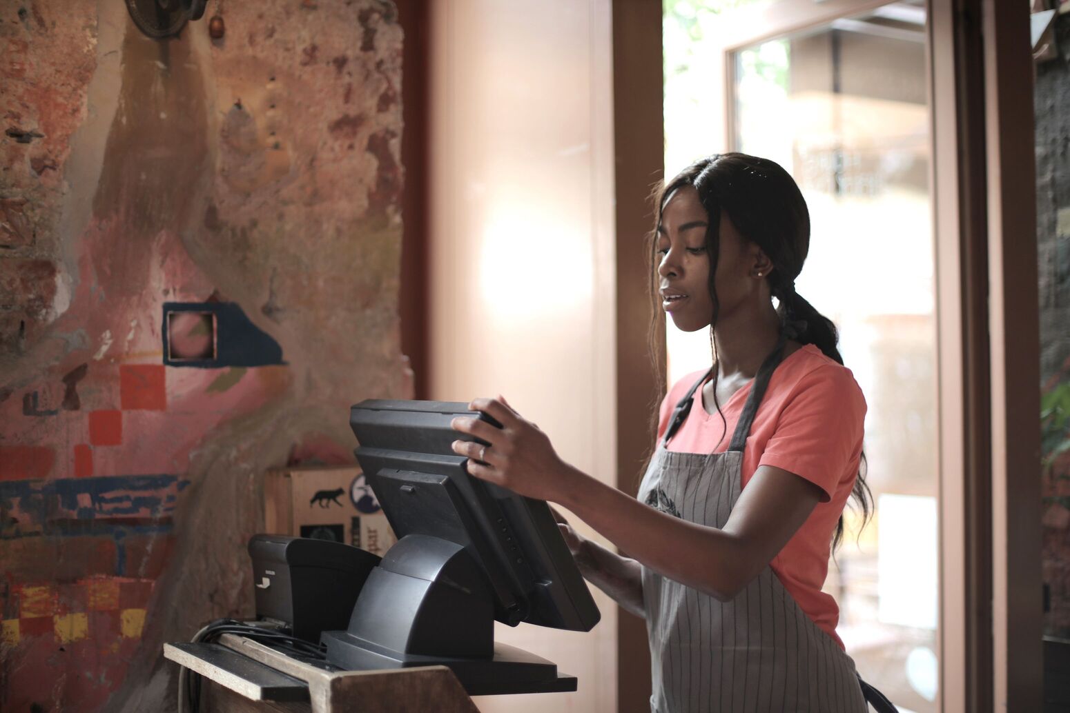 A staff member setting up a POS terminal at the counter